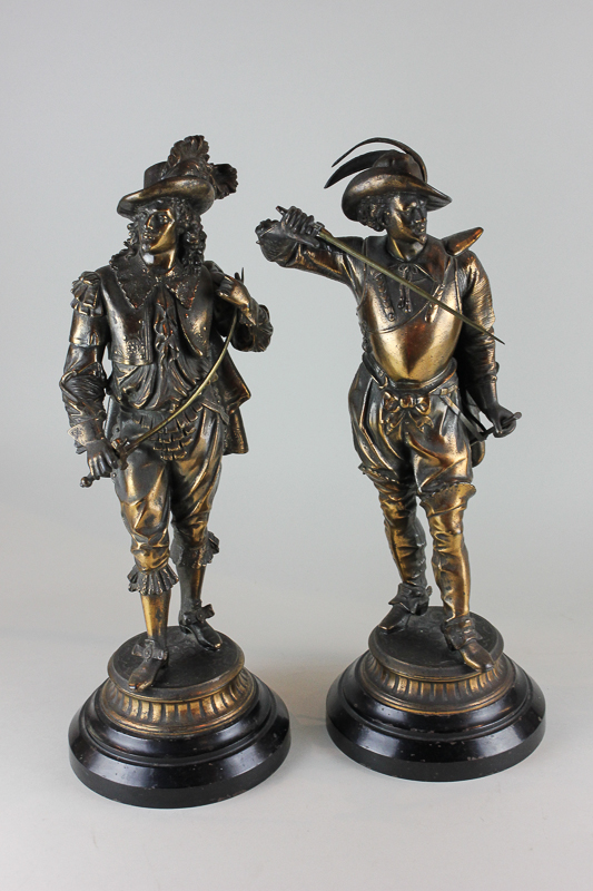 A pair of Victorian bronzed spelter figure ornaments of Cavaliers, both standing with a sword on