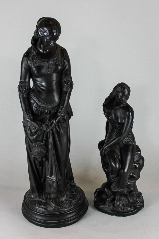 A bronzed figure ornament of a young lady sitting on a rock, signed `Bell Miranda`, 38cm high,