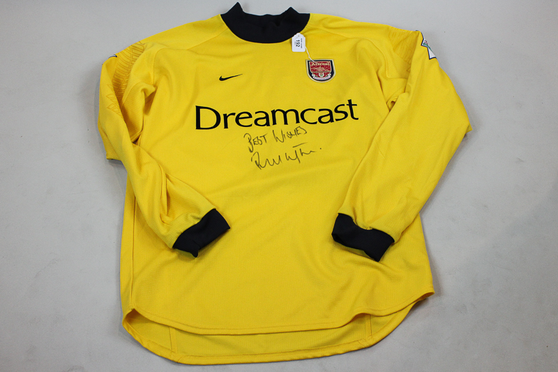 An Ian Wright Arsenal signed yellow `Dreamcast` football shirt