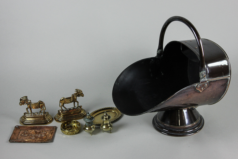 A copper helmet shaped coal scuttle; a pair of brass `donkey` bookends and other small items