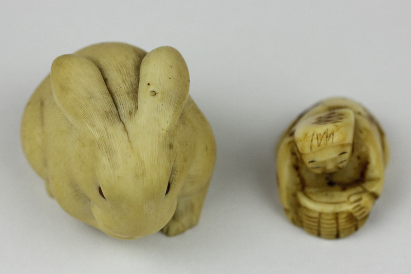 A Japanese netsuke of a rabbit, 4cm; and another of a crouching man with a basket, 3cm
