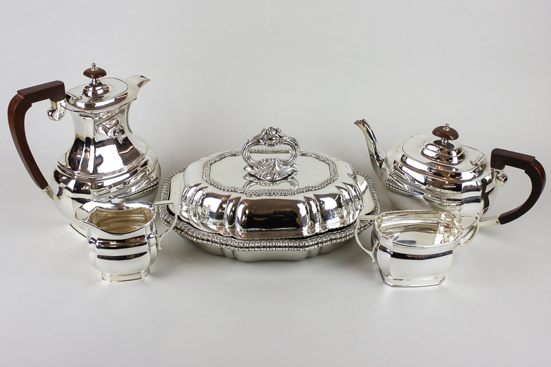 A silver plated four piece tea and coffee set, oval shape with wooden handles; an oval tureen and