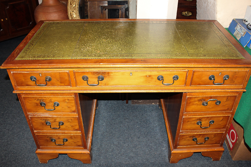 A yew wood pedestal desk with leather inset top and nine drawers, 124cm by 61cm