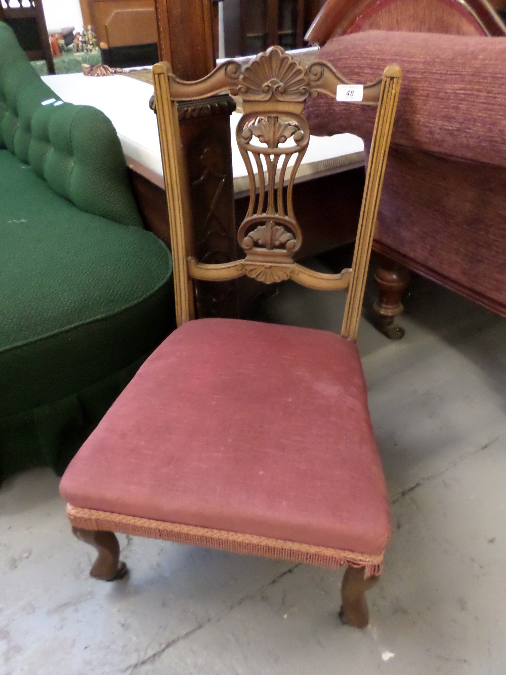 Small nursing chair upholstered in dusky pink fabric