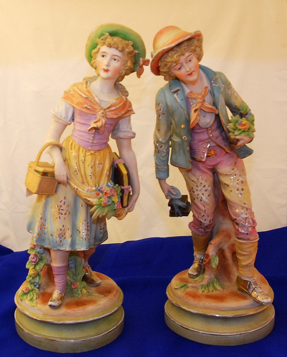 PAIR OF CONTINENTAL BISQUE PORCELAIN FIGURES, BOY AND GIRL, 48CM OVERALL, SPLIT TO UNDER BASE OF