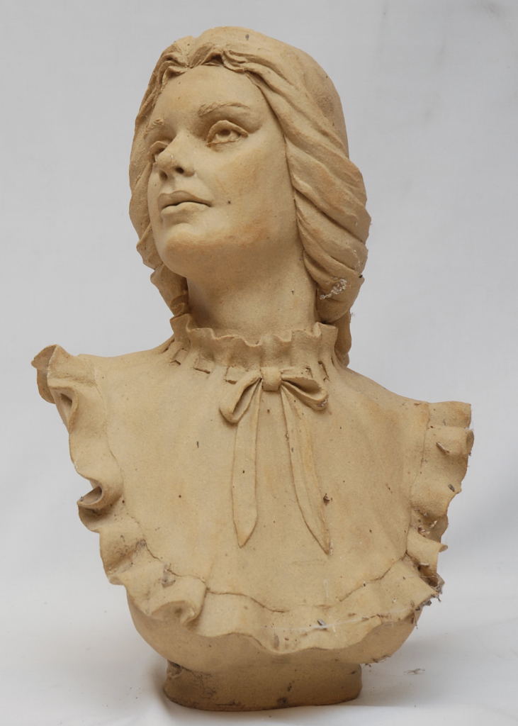 AN ART POTTERY BUST OF A WOMAN WITH FRILLED NECK DRESS,40CM BEARING SIGNATURE W.M. CANN