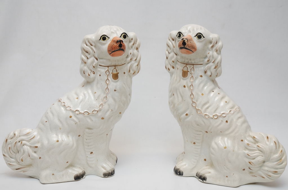 A PAIR OF WHITE STAFFORDSHIRE SPANIELS, HEIGHT 32CM