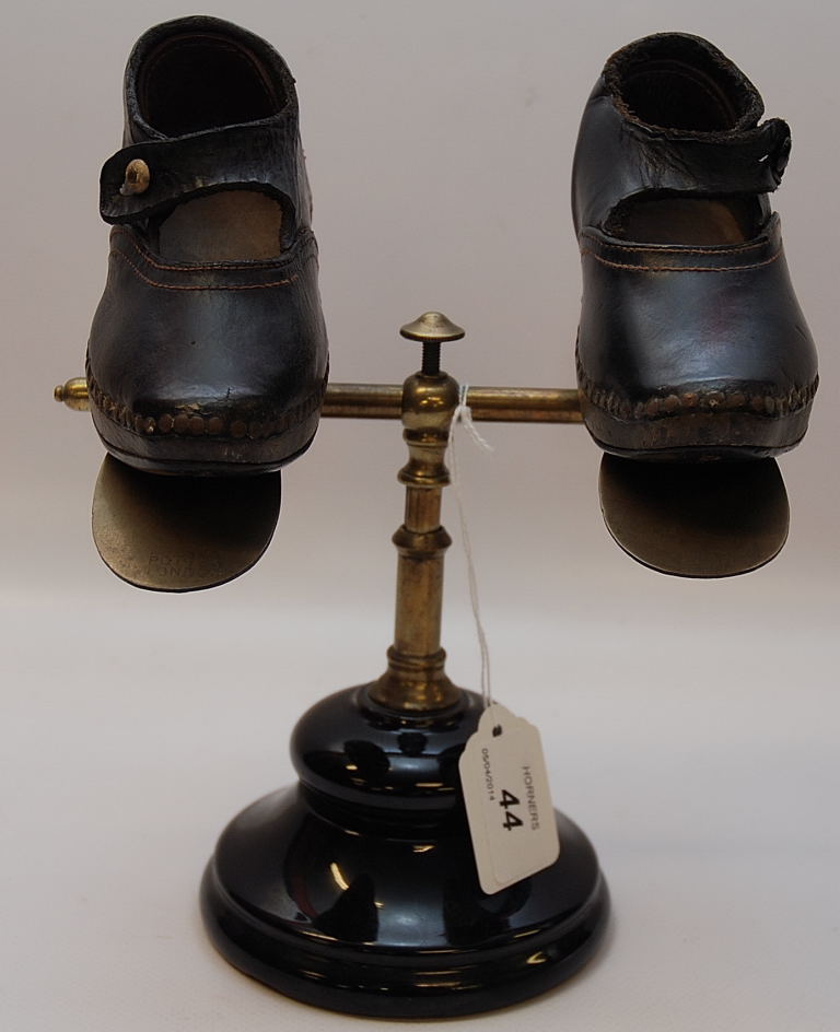 A VICTORIAN BRASS SHOE SHOP WINDOW DISPLAY STAND MARKED POTTER, LONDON AND A PAIR OF HANDMADE