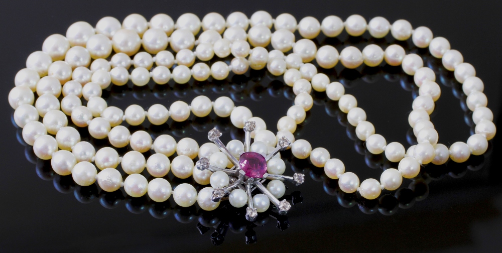 A two strand slightly graduated cultured pearl necklace, with a tourmaline, diamond and pearl