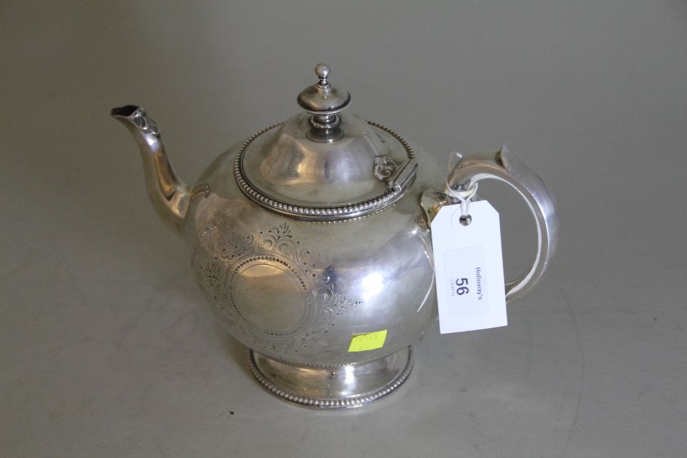 A Victorian heavy silver bullet form teapot, with engraved and beaded decoration, the handle and