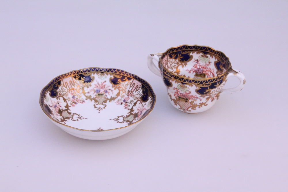 An early 20th century Royal Crown Derby Imari two handled cup and saucer, bearing retail label and