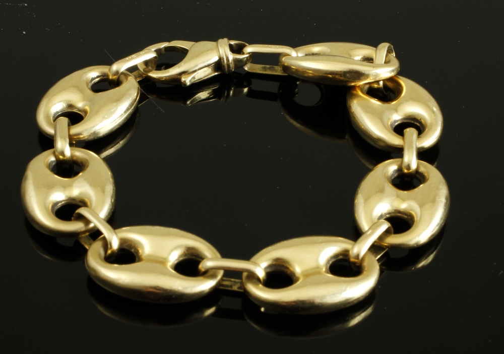 An 18ct gold hollow link bracelet, of large oval links with double cut away circle design