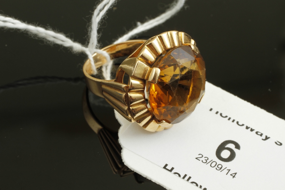 A French single stone citrine dress ring, the large circular citrine, claw set within a frilled