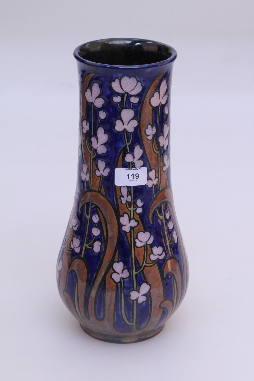 An early 20th century Royal Doulton stoneware baluster vase, with scraffito marked flowers and