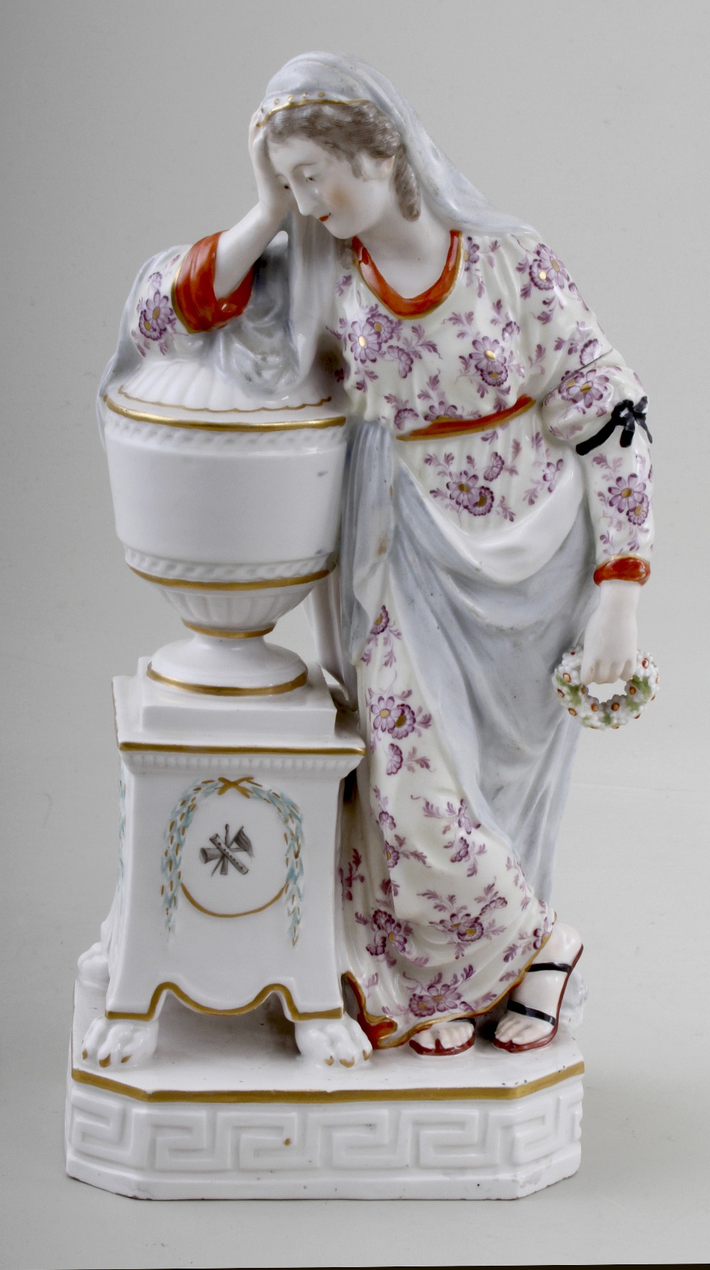 A Derby porcelain figure of Andromache, c.1780, standing with wreath in hand near the funerary urn
