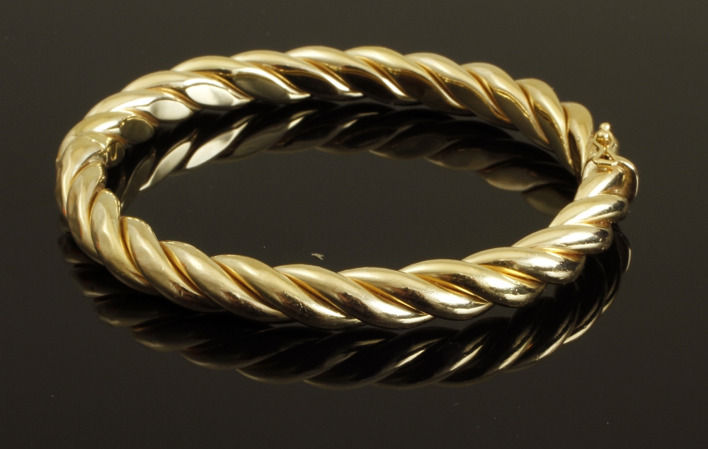 A rope twist design bangle, hinged opening, marked Italy `18K`