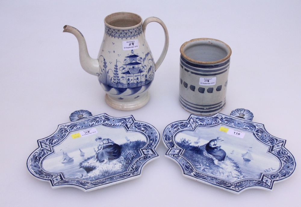 A pair of blue and white Delft wall plaques, each depicting coastal scenes with solitary figure, 28