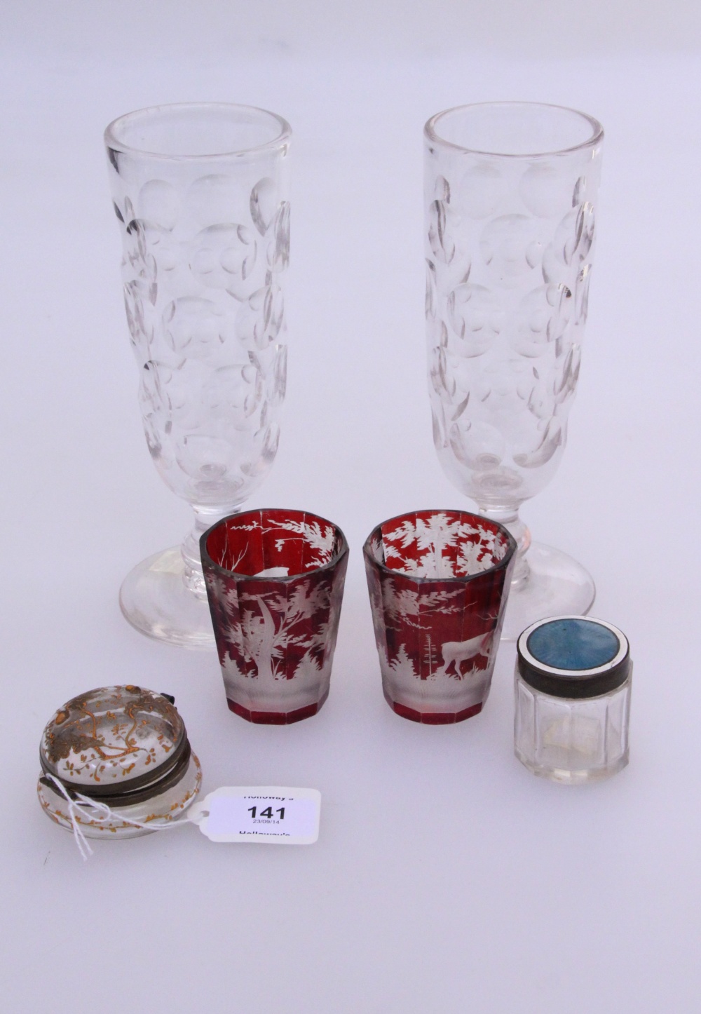 A pair of late 19th century ruby flashed and etched Bohemian glass tumblers, the panelled bodies