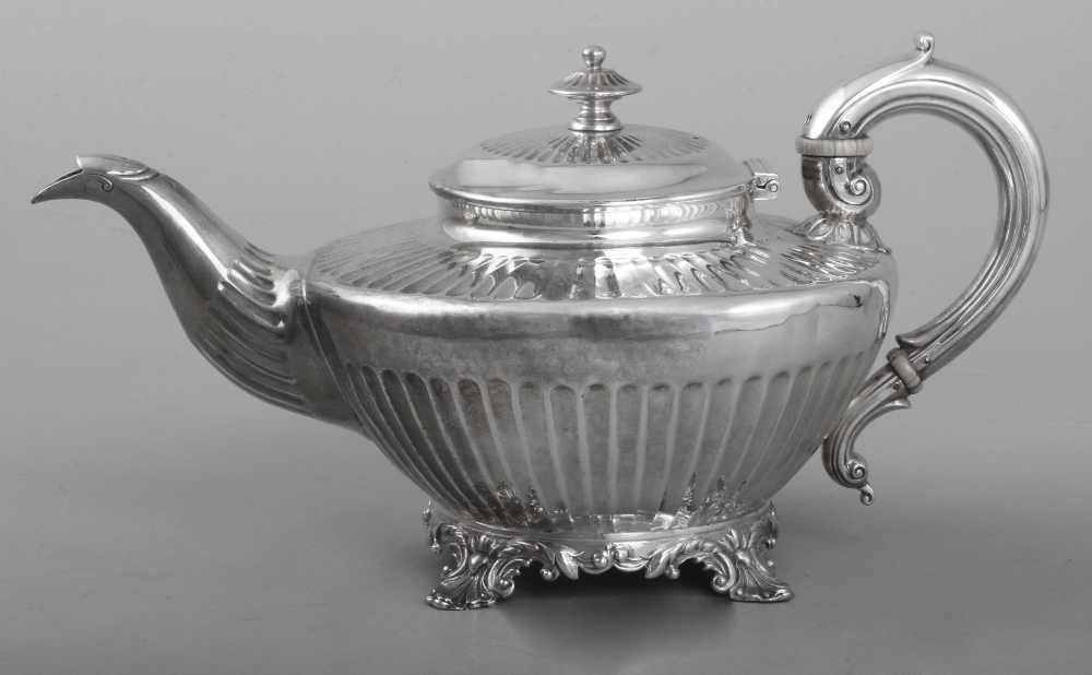 A William IV silver teapot, of squat fluted form, scroll handle, raised on cast acanthus leaf feet,