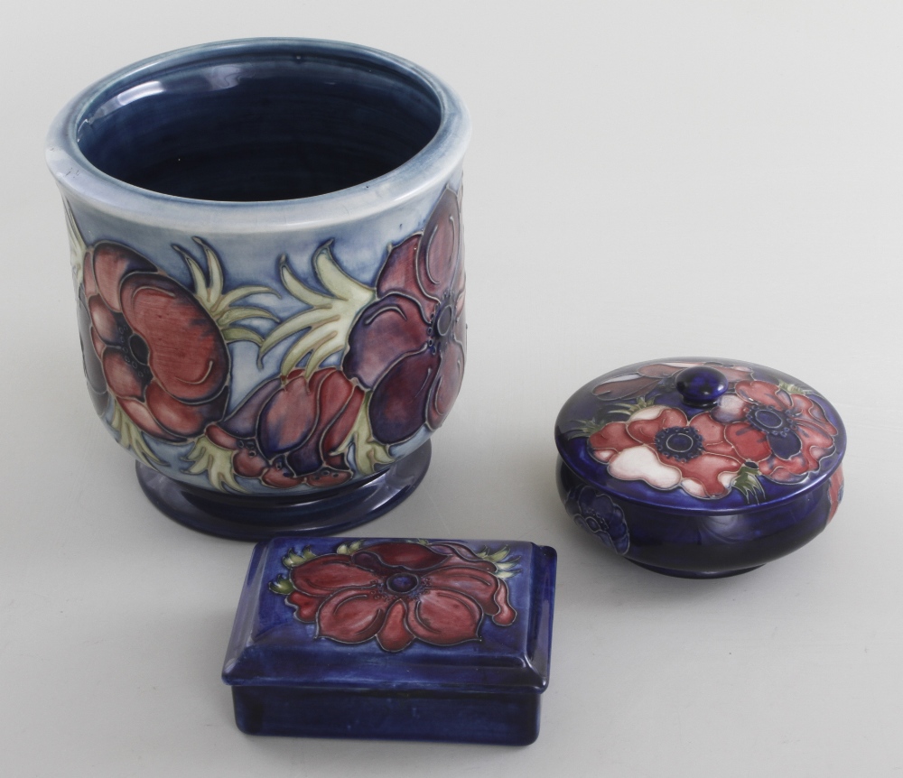 A Moorcroft cachepot, anemone tube lined and painted design, 17.5 cm (6 3/4 in) high, together with