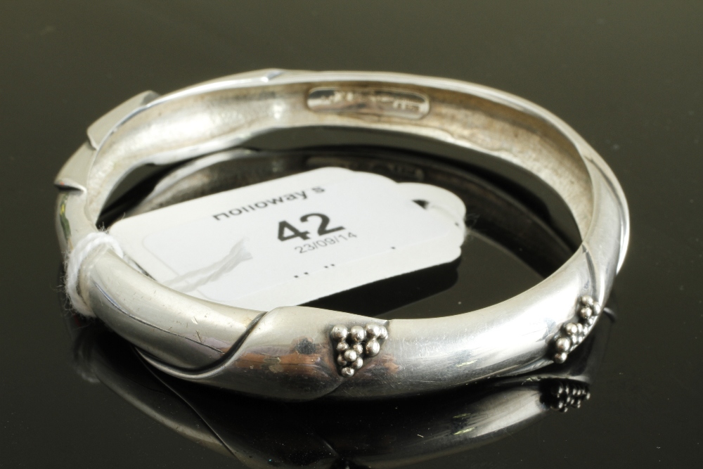 A Georg Jensen bangle, of folded curve design, with beaded detail