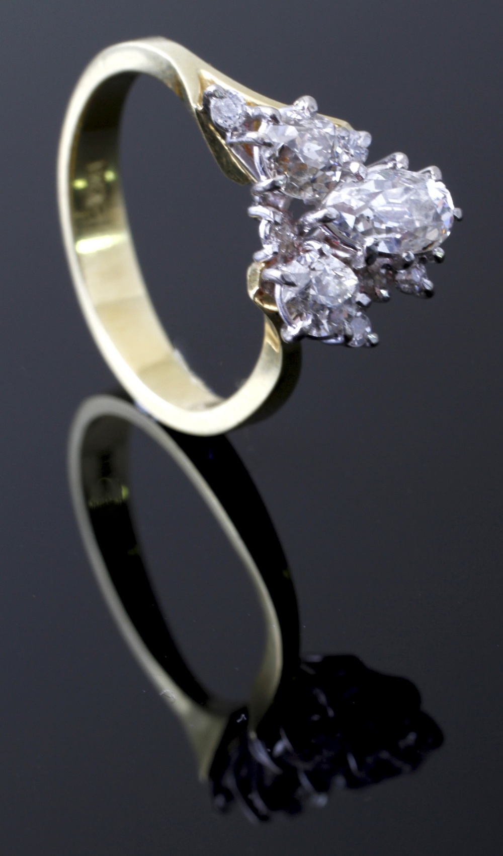 An abstract shaped diamond cluster ring,  comprising a principle pear-shaped diamond together with