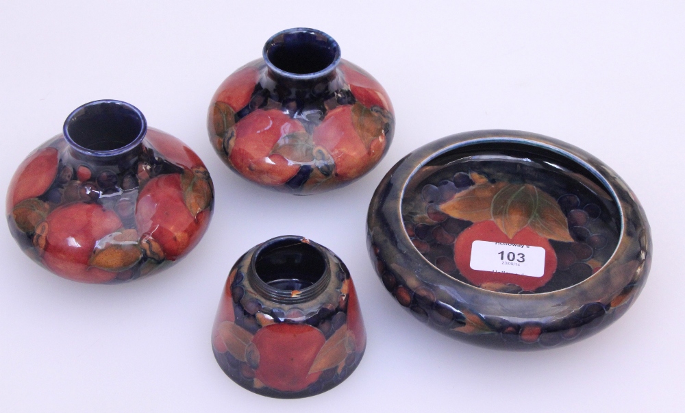 A pair of Moorcroft squat baluster vases, pomegranate design, tube lined and painted in a mottled