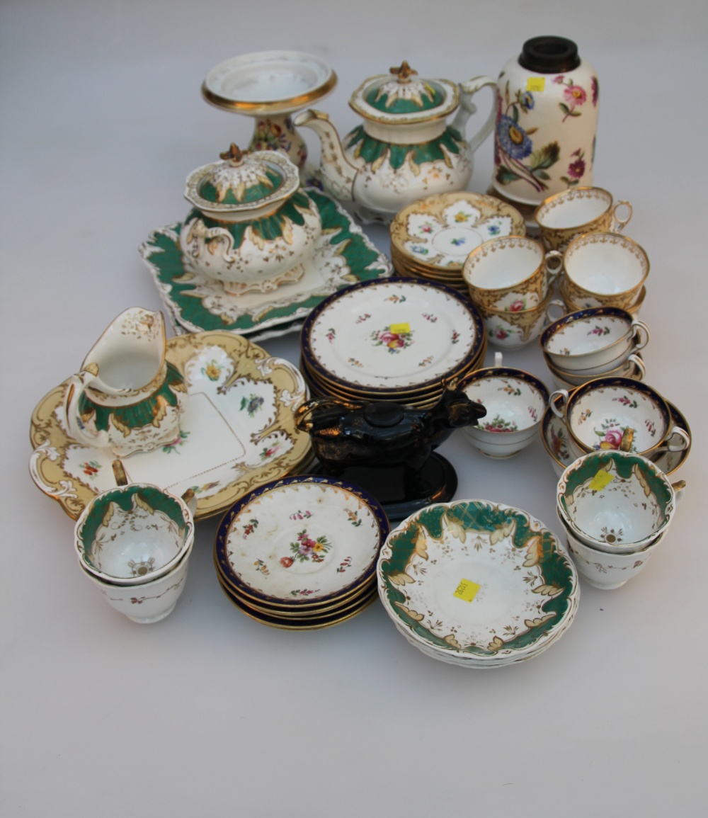 A Victorian bone china part tea service, with beige borders and floral reserves bordered by gilt