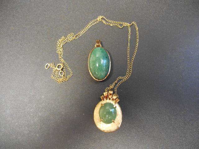 A 14k gold pendant set with jade on necklace chain, together with a yellow metal mounted green stone