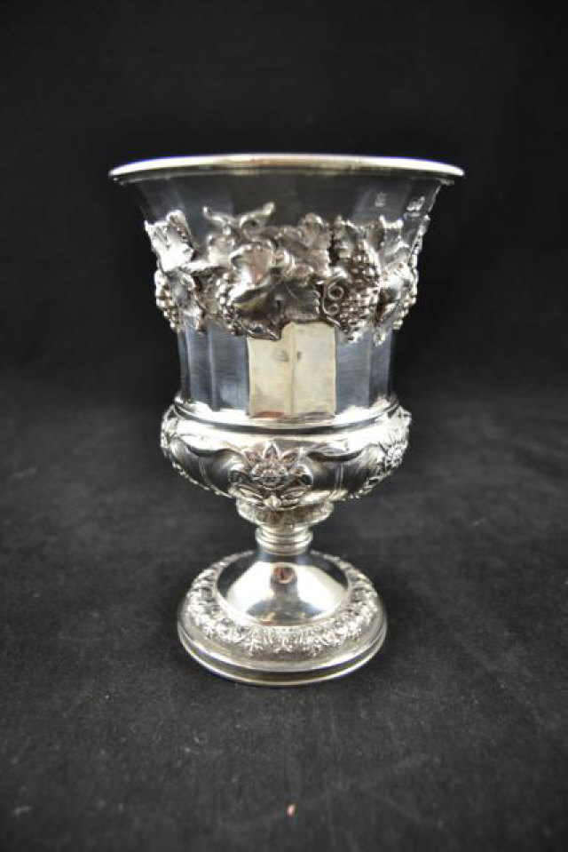 A late Georgian silver goblet with gilt interior, the bowl decorated with a band of fruiting vine,