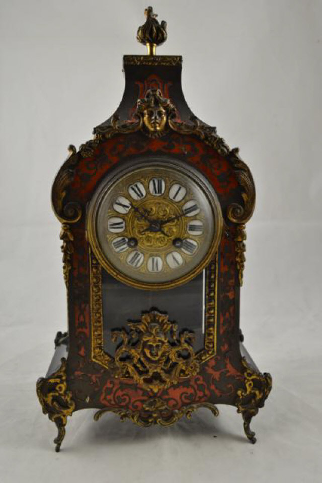 A late 19th century French red boulle mantle clock with gilt decoration, enamel Roman numerals to