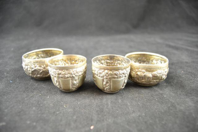 A pair of small Indian embossed bowls with figure and building design - diam 5.5cm, maker Grish