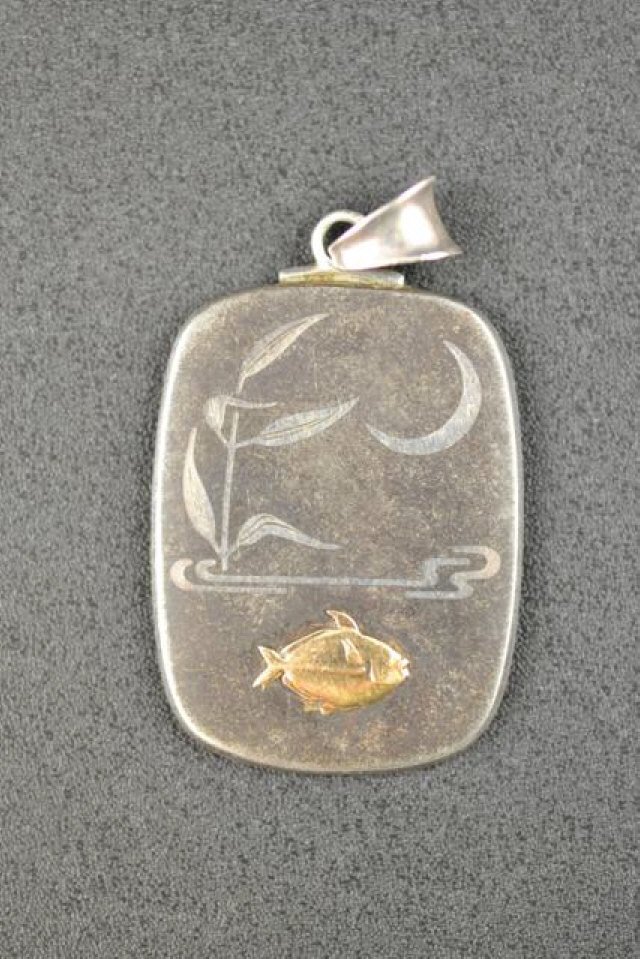 A Georg Jensen stone, silver and gold pendant, the rectangular plaque inlaid with a gold fish and