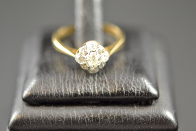 An 18ct gold diamond cluster ring, size L 1/2 - approx gross weight 2.6g