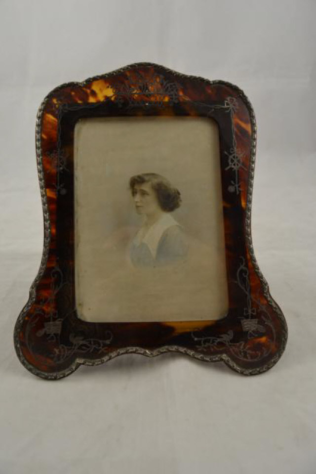 A late 19th/early 20th century silver and tortoiseshell photo frame, easel support, filigree work