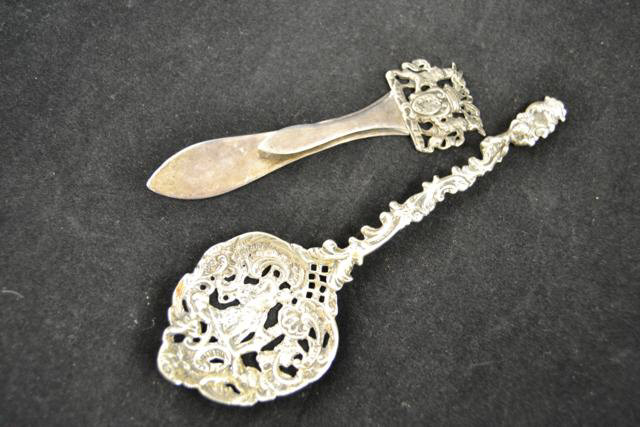 A continental silver page marker with pierced crest, together with a continental white metal spoon