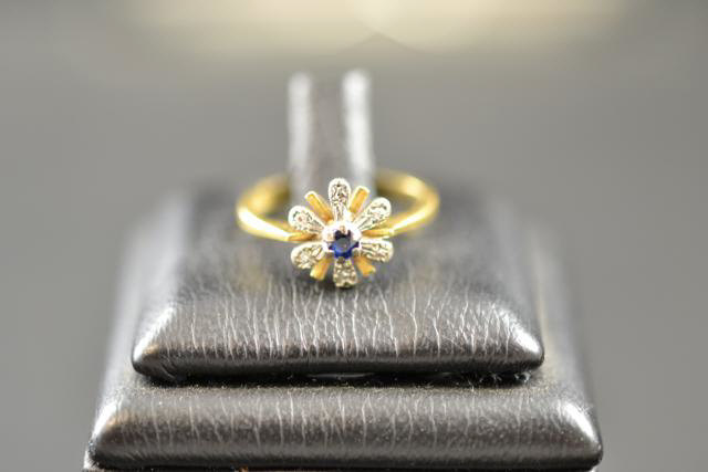 An 18ct gold ring with sapphire and diamonds in floral setting, size I 1/2 - approx gross weight 3.