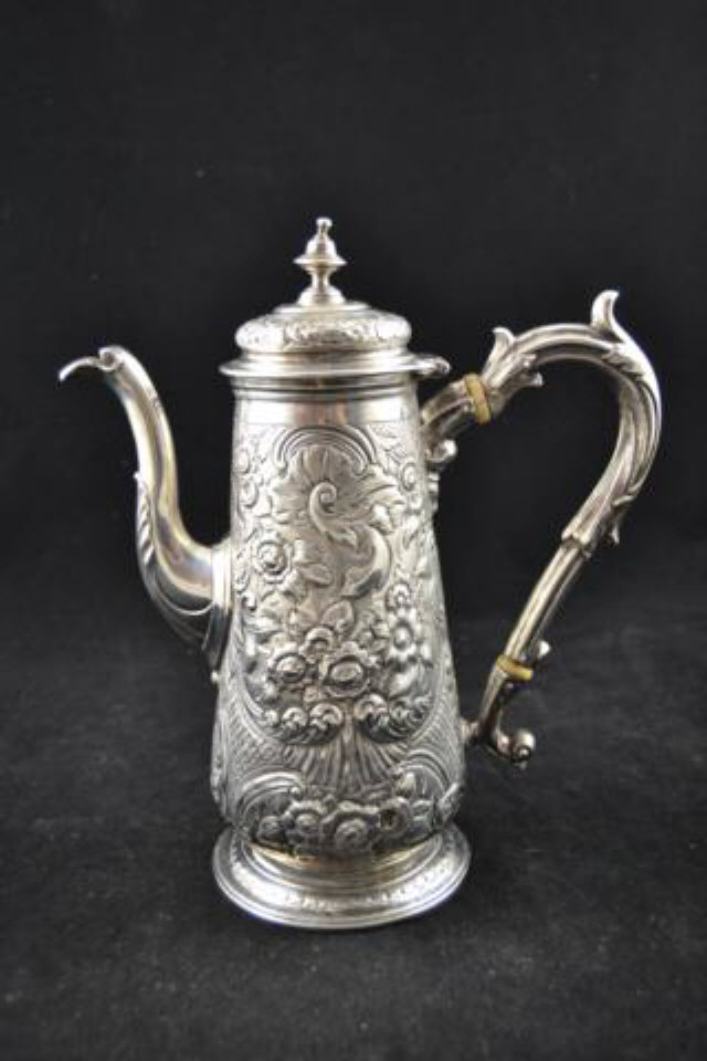 An early 18th century silver chocolate pot and cover, lidded conical form, later embossed with