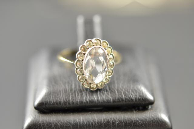 A 9ct gold dress ring with oval centre stone, size N - approx gross weight 2.6g