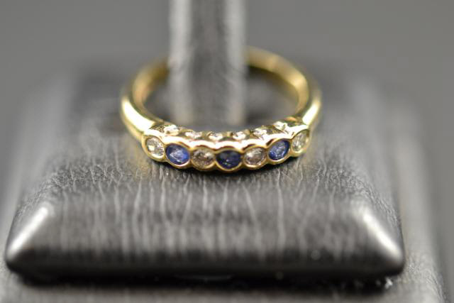 A 9ct gold ring set with diamonds and sapphires, size I 1/2 - approx gross weight 2.2g