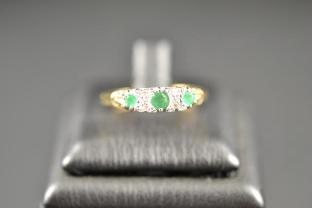 A 9ct gold ring set with diamonds and emeralds, size S 1/2 - approx gross weight 2.6g