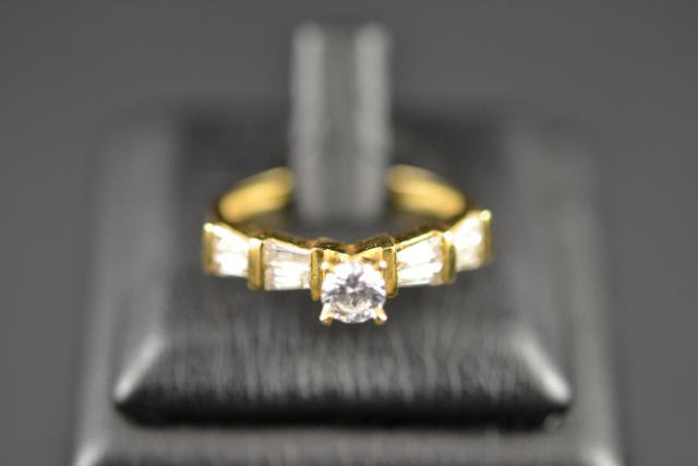 A yellow metal (tests as 18ct gold) ring set with five white sapphires, size O - approx gross weight