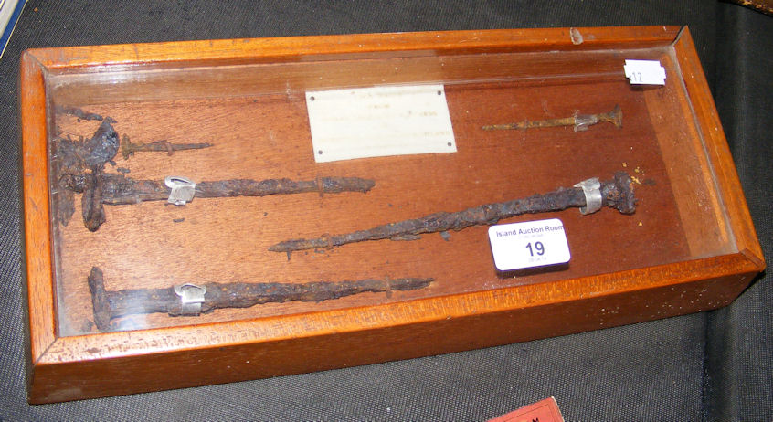 A small display case of five mounted iron nails recovered from a Scottish Roman fortress.