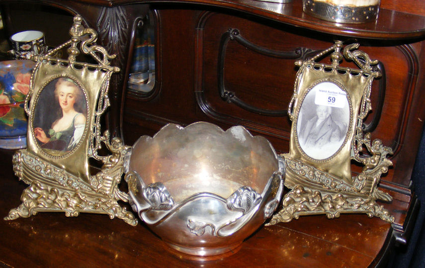 A pair of cast brass standing oval photo frames and an Art Nouveau plated bowl.