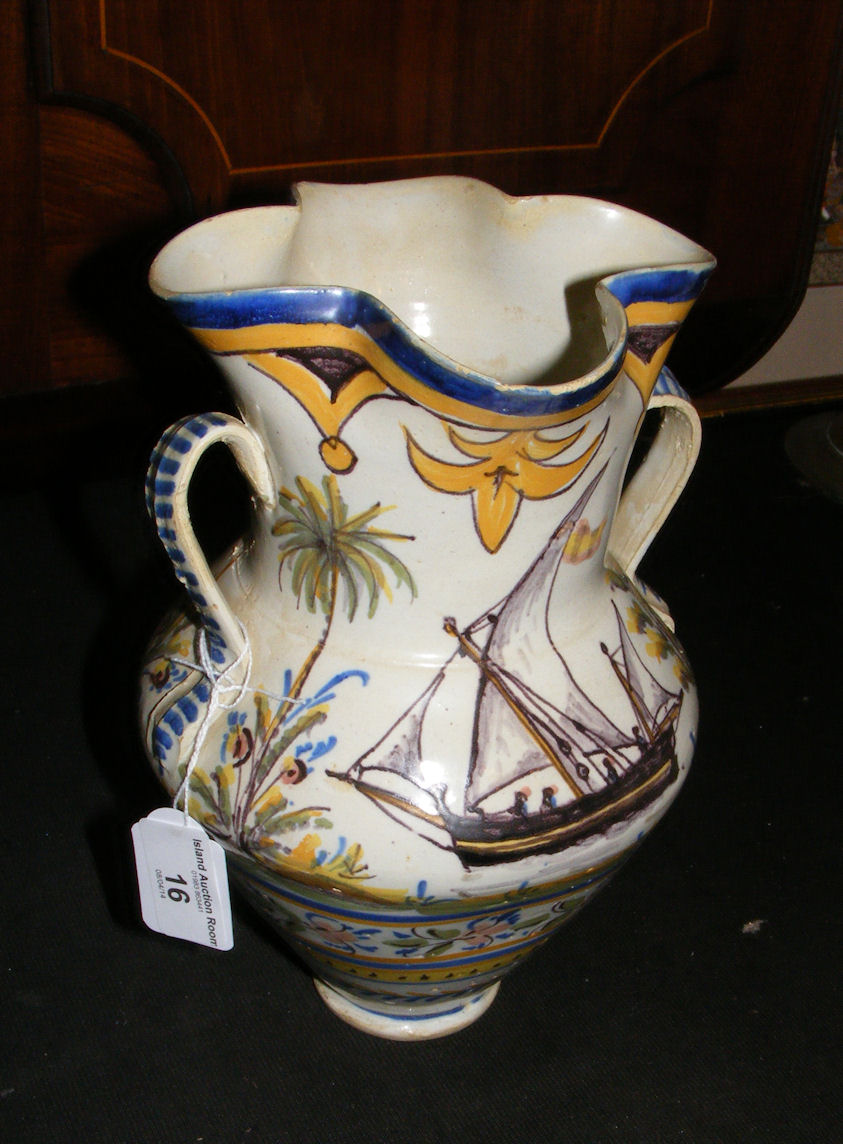 An early continental faience two handled vase, decorated with boat and cattle.