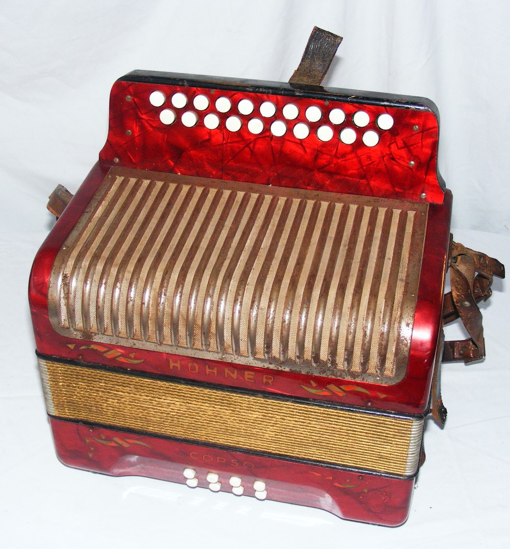 A red Hohner accordion.