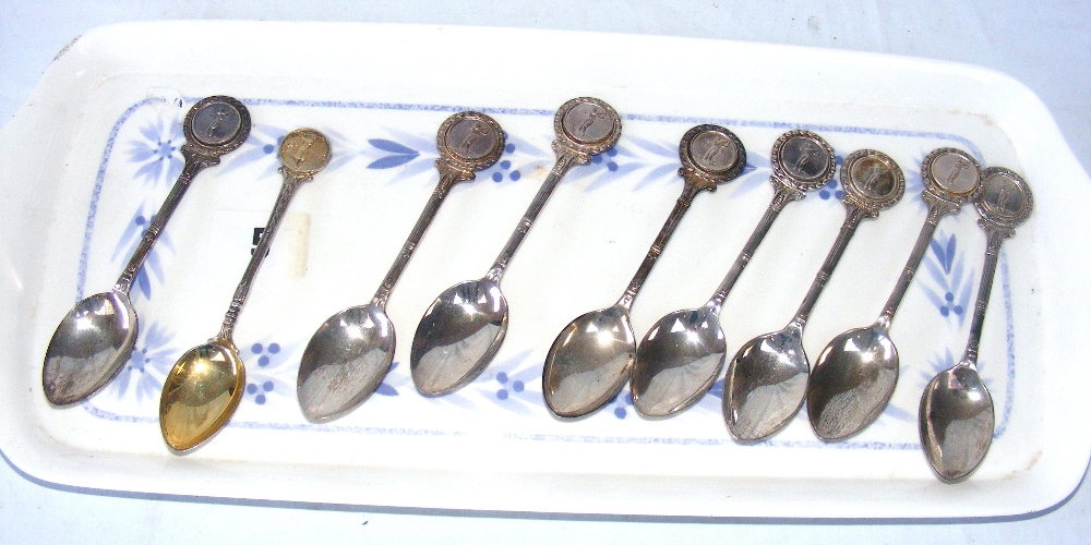 Nine sterling silver golfing spoons, with Birmingham 1960's to 1970's hallmarks, the combined weight