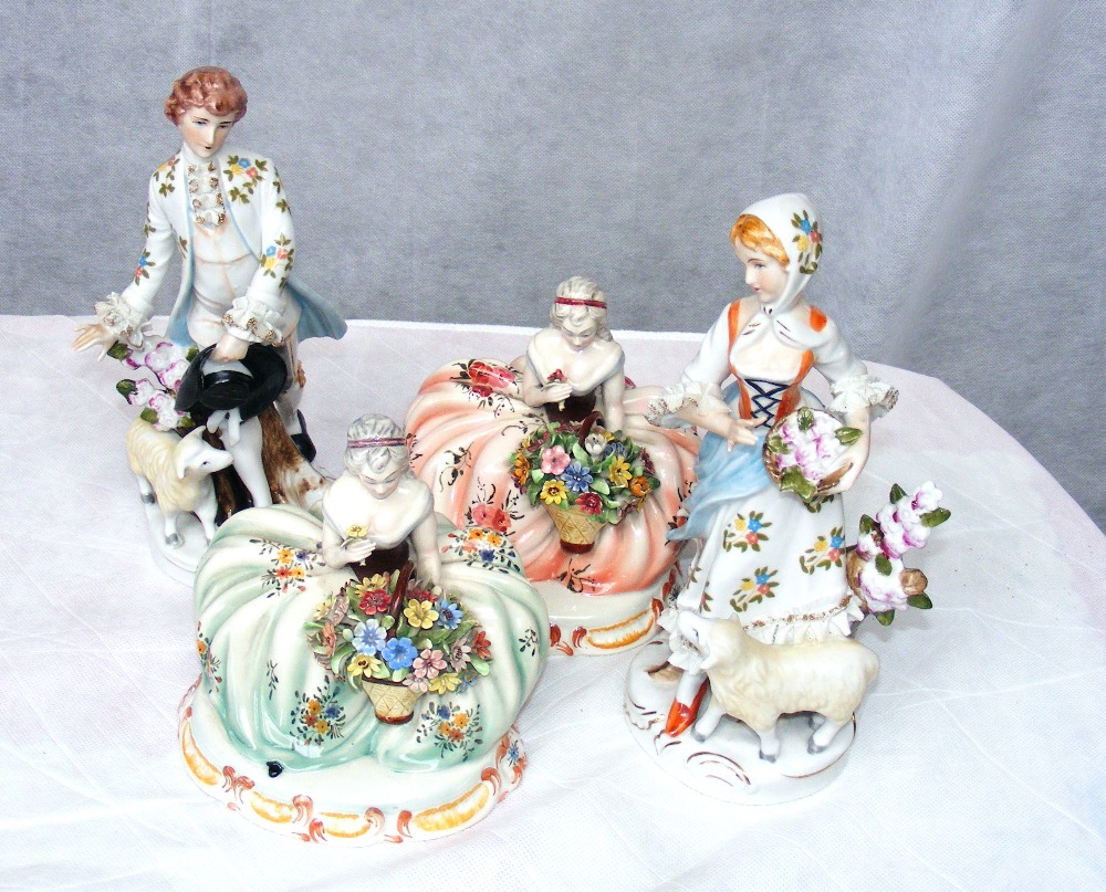 Four continental porcelain figurines.