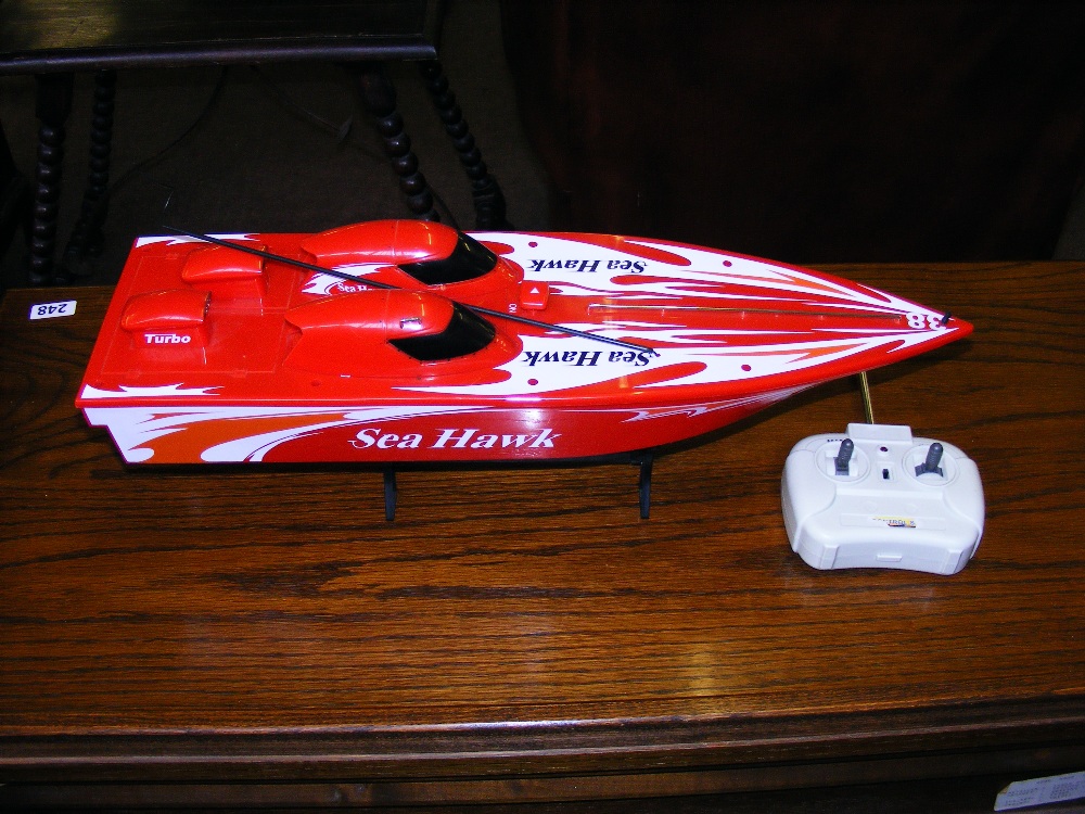 A toy electric power boat & stand.