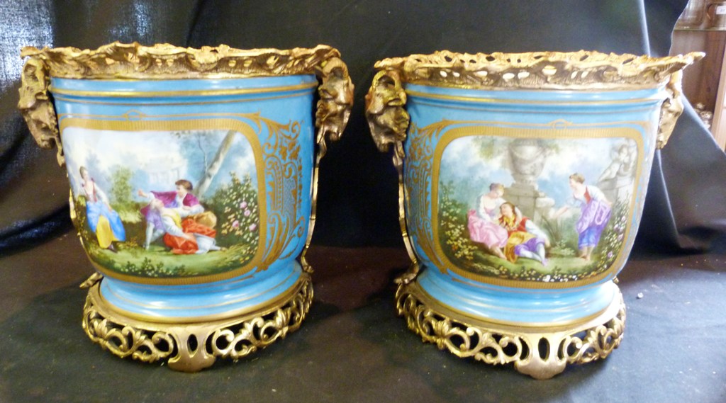 A Pair of Sevres Porcelain Gilt Metal Mounted Urns, each with a reserve depicting figures in